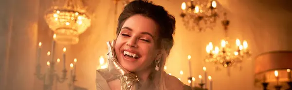 In a warm, candlelit environment, a young woman embraces her enchanting vampire persona with joy. — Stock Photo