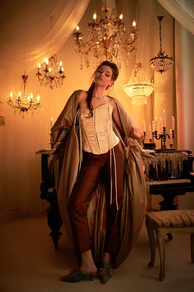 A young woman radiates vampire elegance in a lavish, candlelit, crystal filled room. — Stock Photo