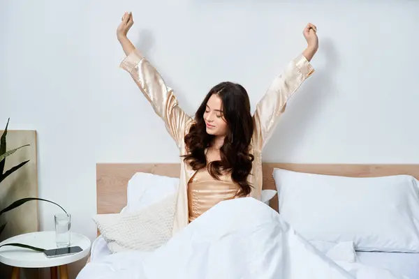 A young woman stretches gracefully in bed, welcoming the new day with a captivating smile. — Stock Photo