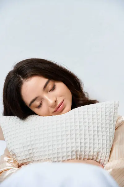 A young woman enjoys a peaceful moment while resting her head on a comfortable pillow. — Stock Photo