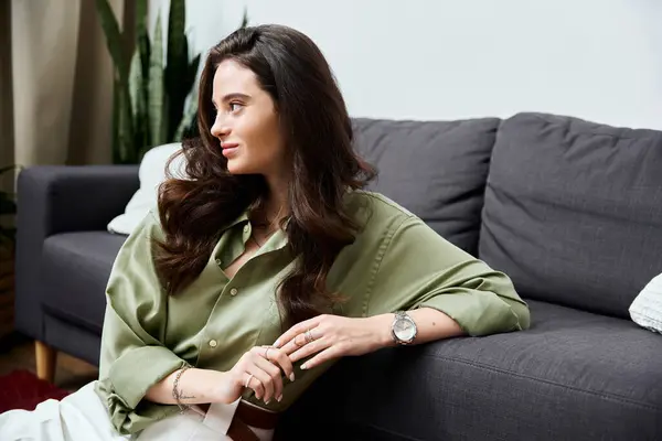 A young woman finds tranquility in her stylish living room filled with plants. — Stock Photo
