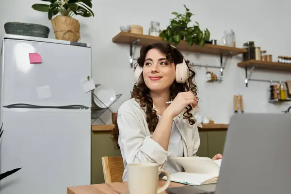 Bright and airy home workspace filled with plants, a young woman engages in creative activities. — Stock Photo