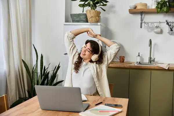 A cheerful young woman stretches and enjoys the calming atmosphere at home, surrounded by plants. — Stock Photo