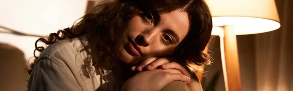 Beautiful young woman lounging comfortably at home, embracing a tranquil moment alone. — Stock Photo