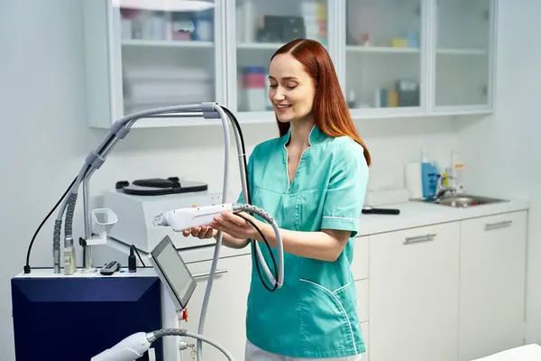 A young dermatologist showcases a modern procedure in a bright, professional clinic. — Stock Photo