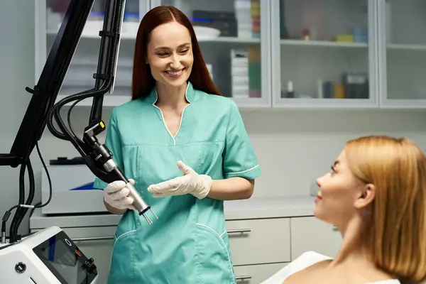 A skilled dermatologist explains a procedure to a young woman in a bright clinic setting. — Stock Photo