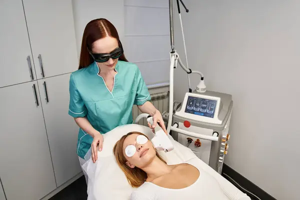 A young woman relaxes during a soothing professional dermatology treatment. — Stock Photo