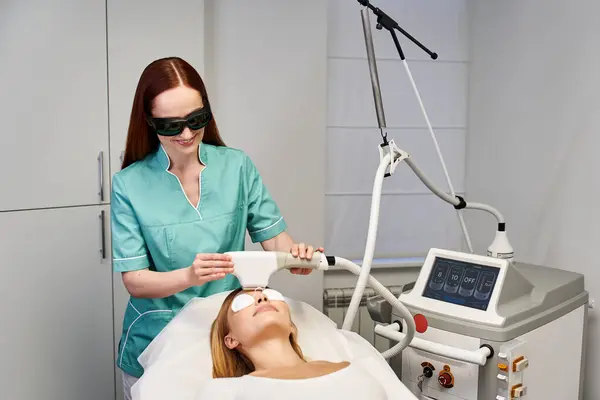 A skilled dermatologist performs a skin treatment on a young woman to improve her complexion. — Stock Photo