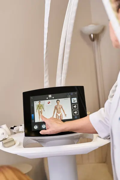 A young dermatologist treats a client using advanced skin procedure technology. — Stock Photo