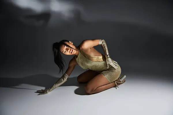 Stunning young woman poses elegantly in chic attire with creative lighting effects. — Stock Photo