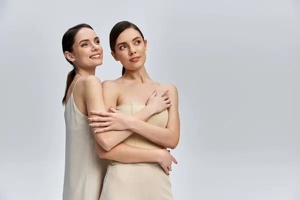 Two stylish sisters embrace, showcasing their close bond in a modern setting. — Stock Photo