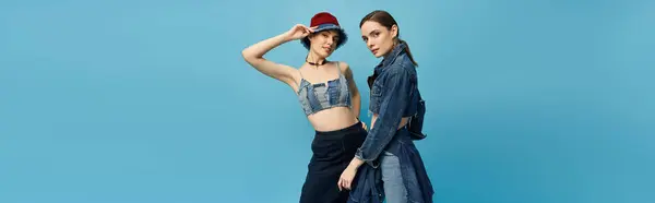 Sisters radiate beauty and style while posing elegantly, highlighting their fashionable outfits. — Stock Photo