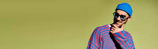 A young man showcases his unique fashion sense in a stylish outfit with trendy sunglasses, banner — Stock Photo