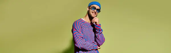 This stylish young man models a fashionable outfit while posing with confidence in a studio, banner — Stock Photo