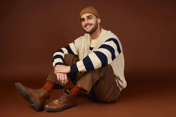 Handsome young man poses in trendy winter outfit, showcasing his fashion sense with flair. — Stock Photo