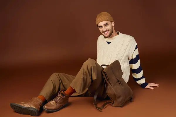 A handsome young man models a fashionable winter outfit, highlighting his unique sense of style. — Stock Photo