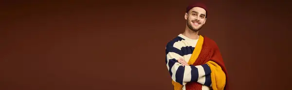 Handsome young man poses confidently in a fashionable outfit with a beanie, showcasing style, banner — Stock Photo