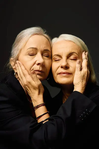 Two mature women share an intimate moment, radiating love and connection in a minimalistic setting. — Stock Photo