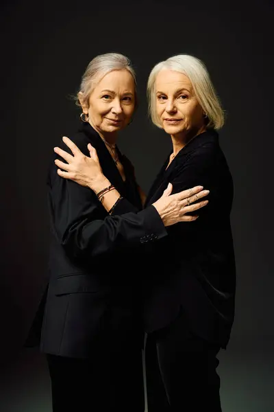 Two stylish women embrace warmly, showcasing their love and confidence in a chic setting. — Stock Photo