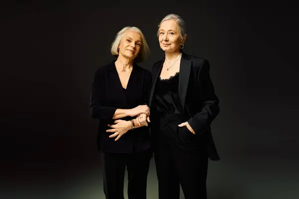 Two mature women exude elegance and confidence, showcasing their love in a stylish pose. — Stock Photo