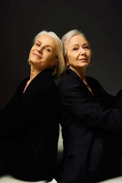 Two stylish women share an intimate moment, showcasing their connection and fashionable vibe. — Stock Photo