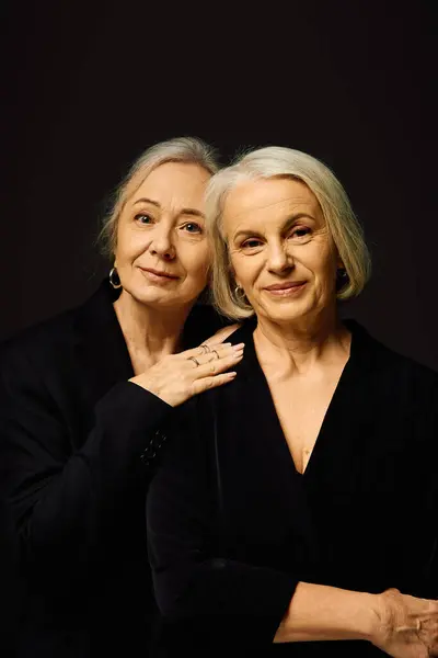 Two elegant women share a heartfelt embrace, showcasing their love and style in a chic setting. — Stock Photo