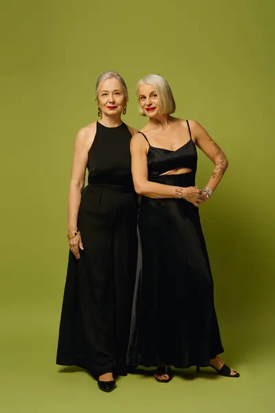 Two stylish women exude confidence and romance, celebrating their bond in elegant attire. — Stock Photo