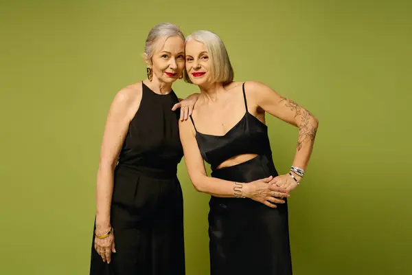 Two mature women express their bond and confidence, radiating love and fashion in a trendy setting. — Stock Photo