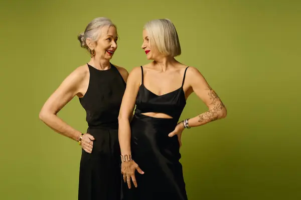 Two women share a joyful moment, celebrating love and style in an artistic setting. — Stock Photo