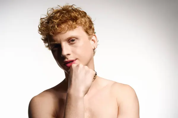 A young handsome man showcases his trendy style with a confident pose and playful expression. — Stock Photo