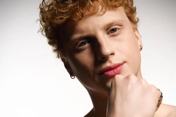 Young man showing off his fashionable style while thoughtfully posing against a neutral backdrop. — Stock Photo