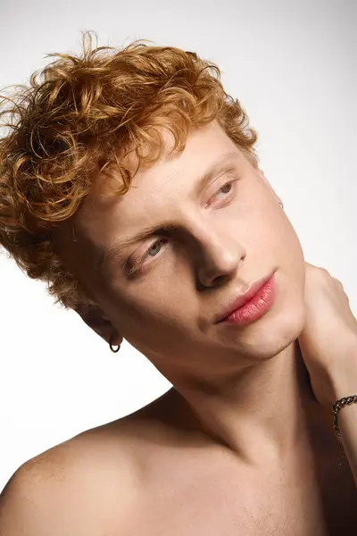 Young man with striking features poses, showcasing his fashion sense and captivating charm. — Stock Photo