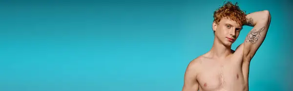 A confident young man showcases his style against a striking blue background. — Stock Photo
