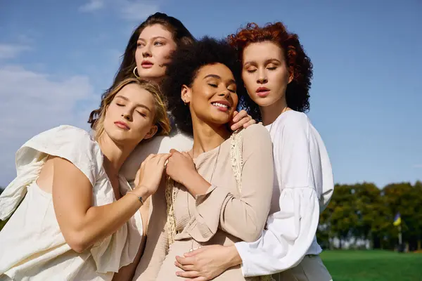 Four stylish women exude confidence and beauty under the sunny sky, surrounded by nature. — Stock Photo