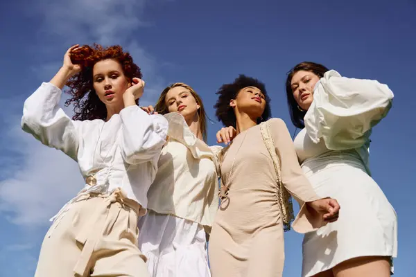 Four fashionable women enjoy a sunny day in the park, showcasing their unique styles and confidence. — Stock Photo