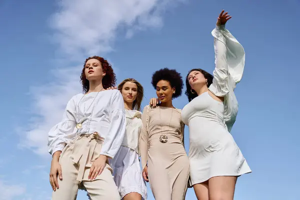 Four stylish women radiate confidence and fashion in the spring outdoors. — Stock Photo