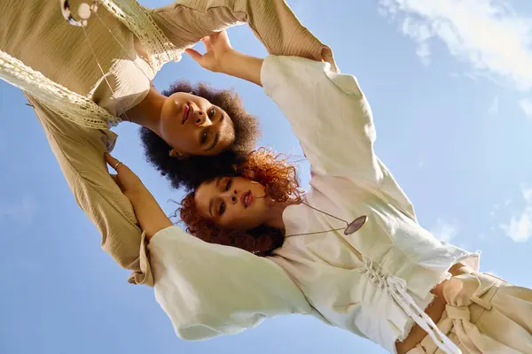 Two stylish women exude confidence while posing playfully in a sunny park during spring. — Stock Photo