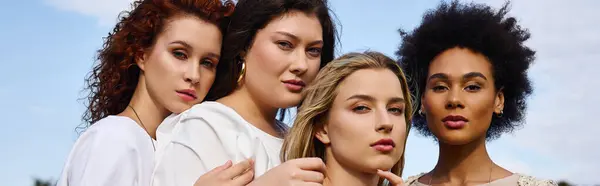 Four fashionable women exude confidence in a sunny outdoor park during springtime. — Stock Photo