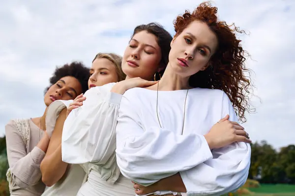Four chic women exude confidence in a sunny spring park, embracing natures beauty. — Stock Photo