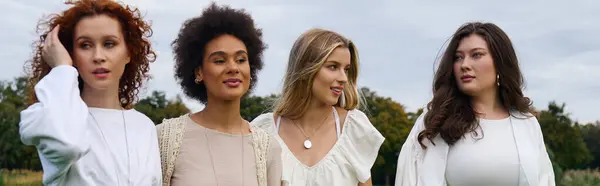 Four stylish women enjoy a serene moment in nature, showcasing their confidence and chic outfits. — Stock Photo