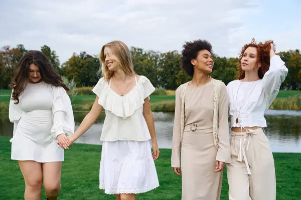 Four fashionable women exude confidence while enjoying a sunny day in a vibrant park. — Stock Photo