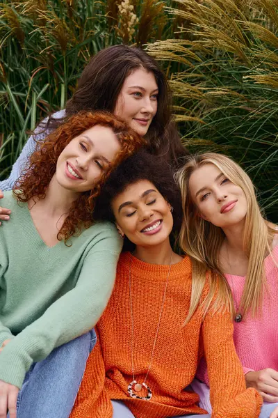 Four stylish friends flaunt their outfits, celebrating the beauty of spring outdoors. — Stock Photo
