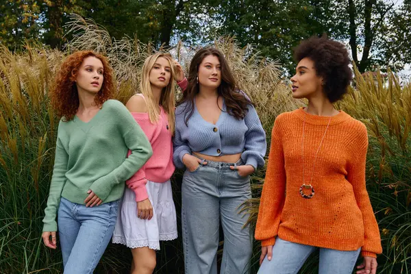 Four stylish women radiate confidence on a sunny spring day, showcasing chic fashion. — Stock Photo