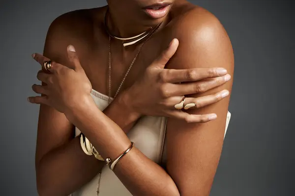 Una splendida donna afroamericana mette in mostra gioielli squisiti mentre abbraccia il suo stile alla moda. — Foto stock