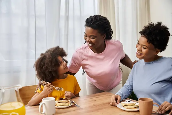 A young LGBT family enjoys a delightful breakfast together, filled with laughter and love. — Stock Photo