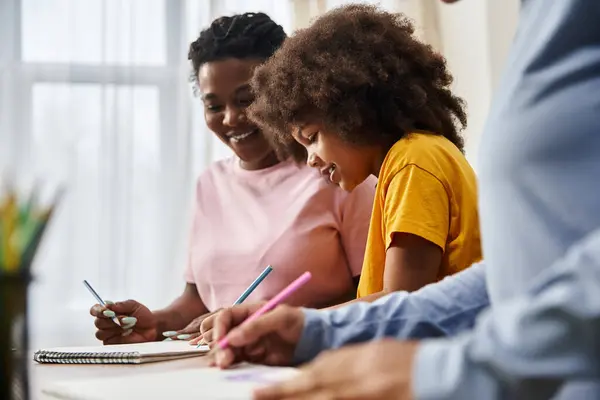 A loving family enjoying art time together in their cozy home, creating lasting memories and smiles. — Stock Photo