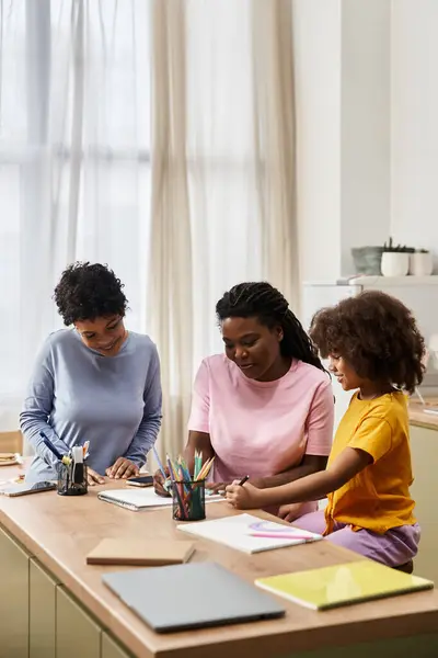 Three family members engage in a creative activity, bonding over art and laughter indoors. — Stock Photo