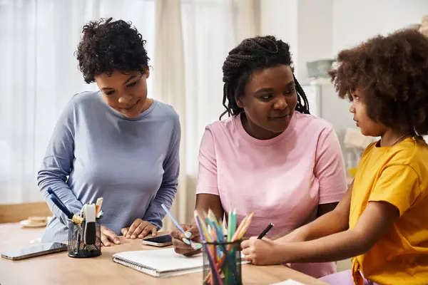 A joyful family engages in colorful art activities while bonding together at home. — Stock Photo