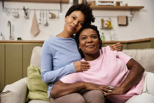 Two loving women embrace each other while enjoying a warm moment. — Stock Photo