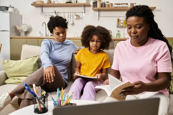 A family enjoys quality time together, sharing stories and laughter in a warm living room setting. — Stock Photo